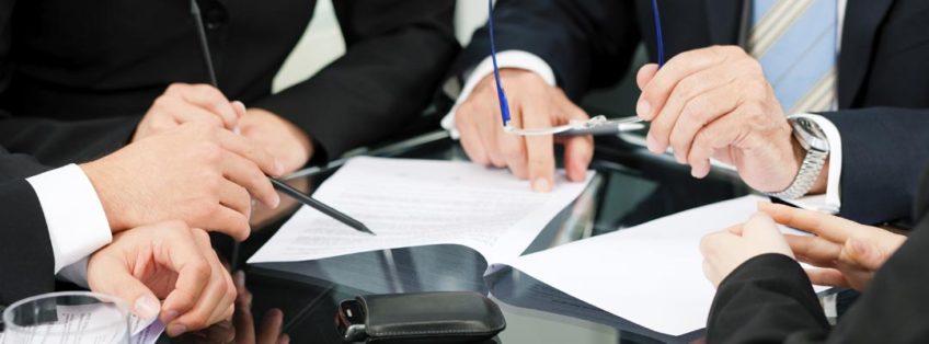 business people sat around a table in a meeting