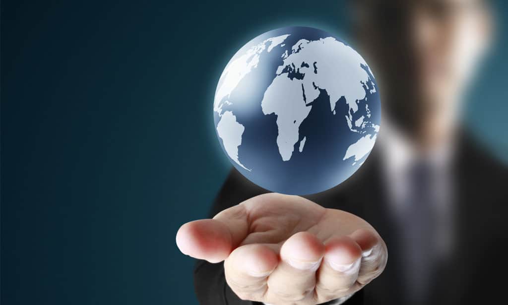 man holding out hand with a floating globe graphic