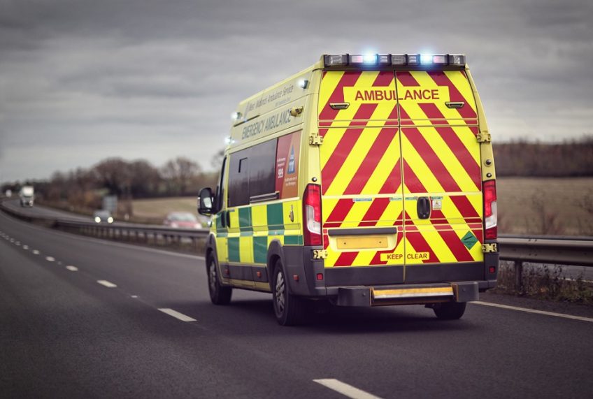 ambulance driving down a road