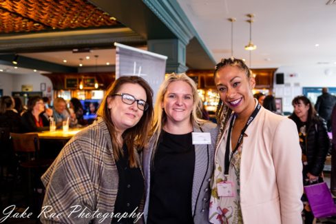 image of three women smiling together at the event