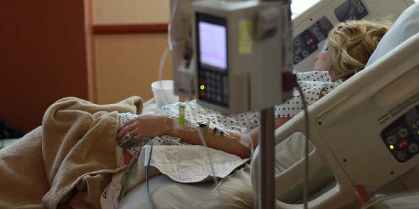 female patient lying in hospital bed