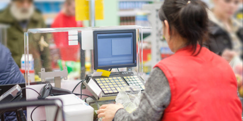 woman working at supermarket checkout