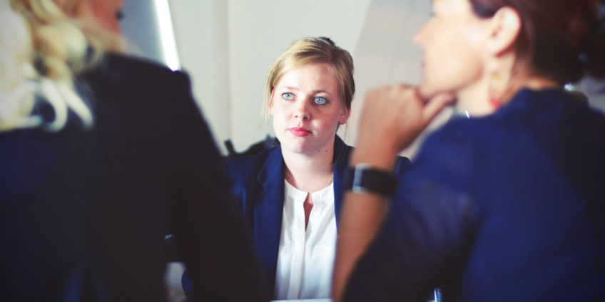 mediator sat between two conflicting women during a discussion