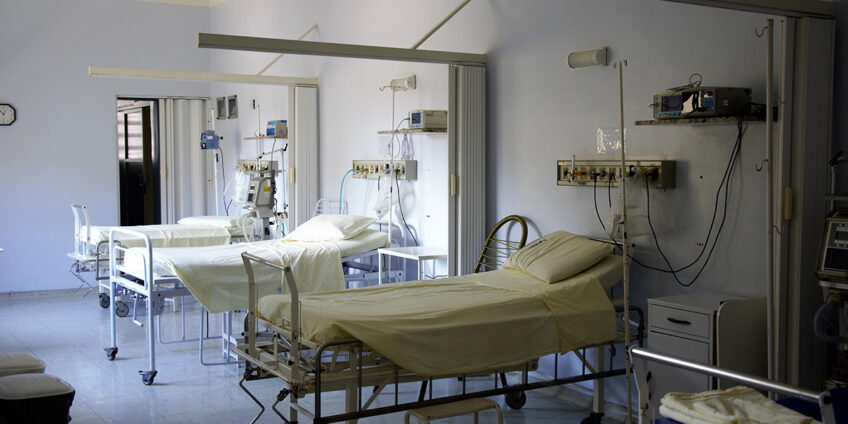 hospital ward with empty hospital beds